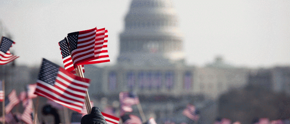 US Capitol with waving American flags