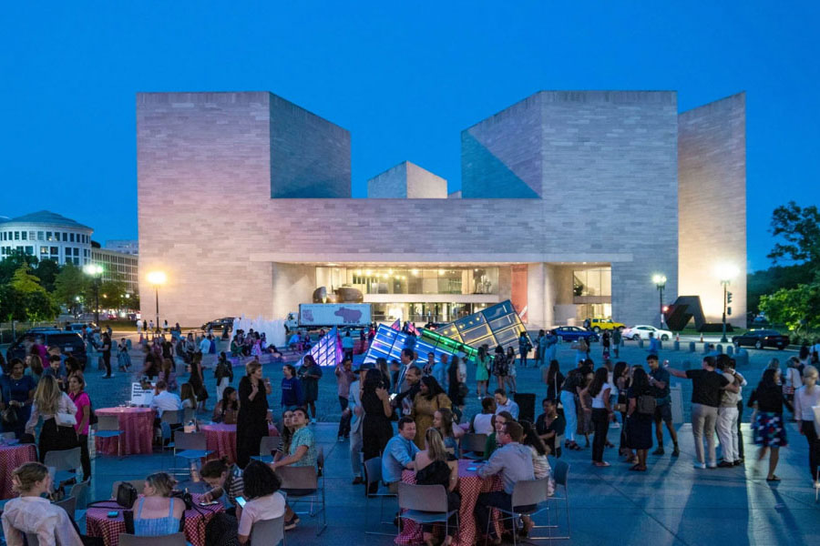 Crowd outside of the National Gallery of Art celebrating at a party at night